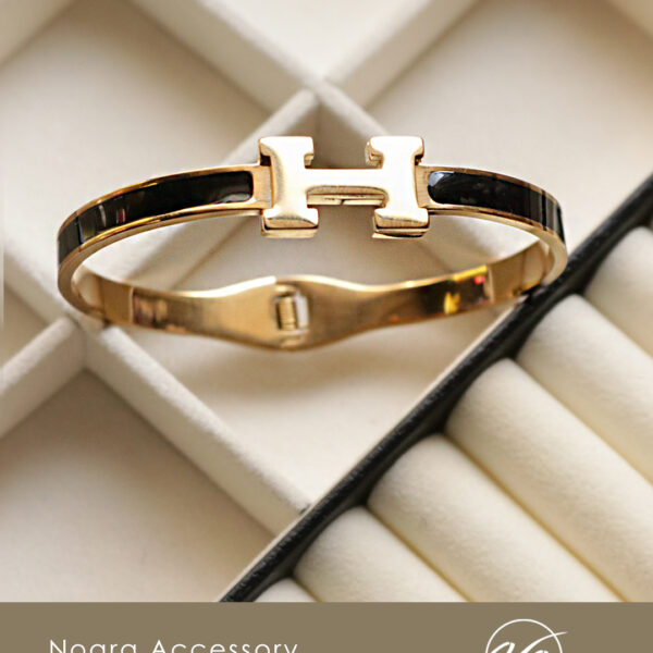 دستبند بنگل هرمس مشکی طلایی